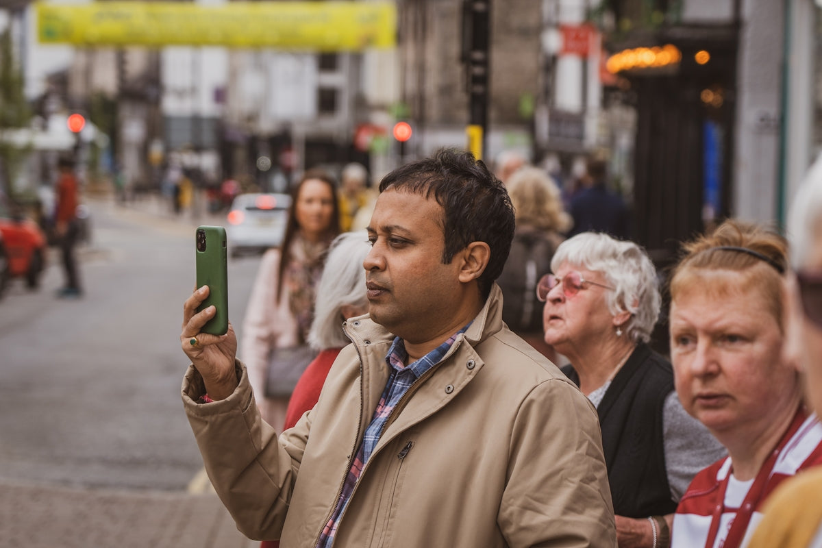 a man taking a picture of himself on his cell phone