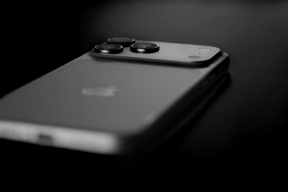 Smartphone with multiple camera lenses on dark background
